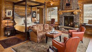Log Home Bedroom with Fireplace - Virginian