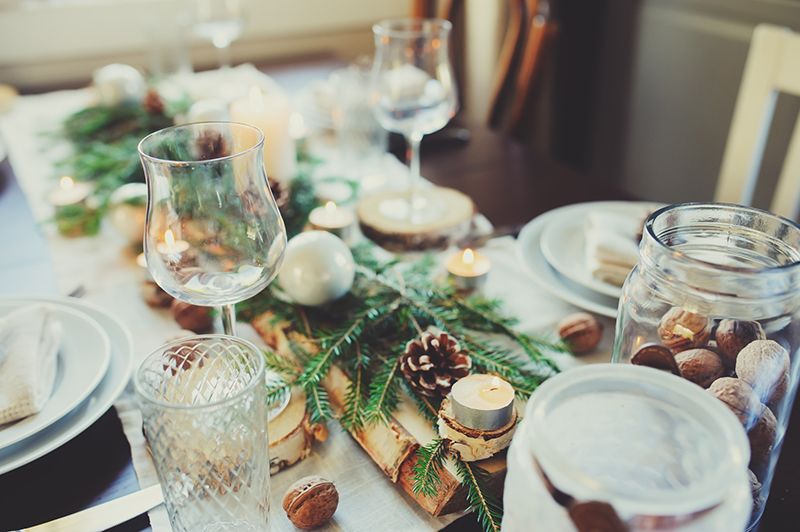 Table setting for celebration Christmas and New Year Holidays. Festive white table at home with rustic details