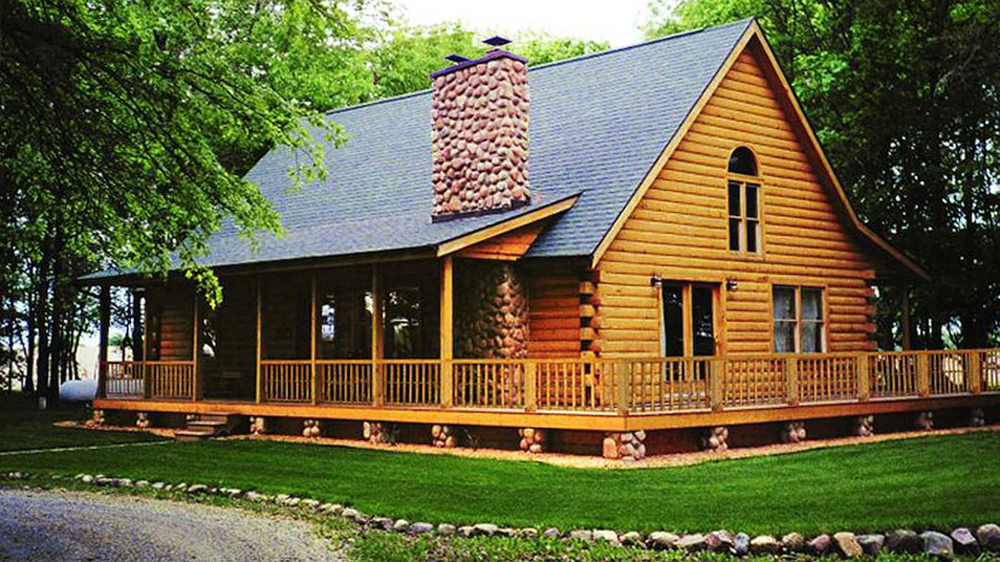 Exterior view of the Madison log home, featuring a spacious porch and large windows framed by wooden logs