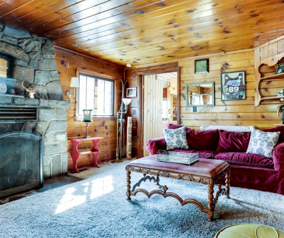 Interior of Log Home with Stone Fireplace and Red Couch