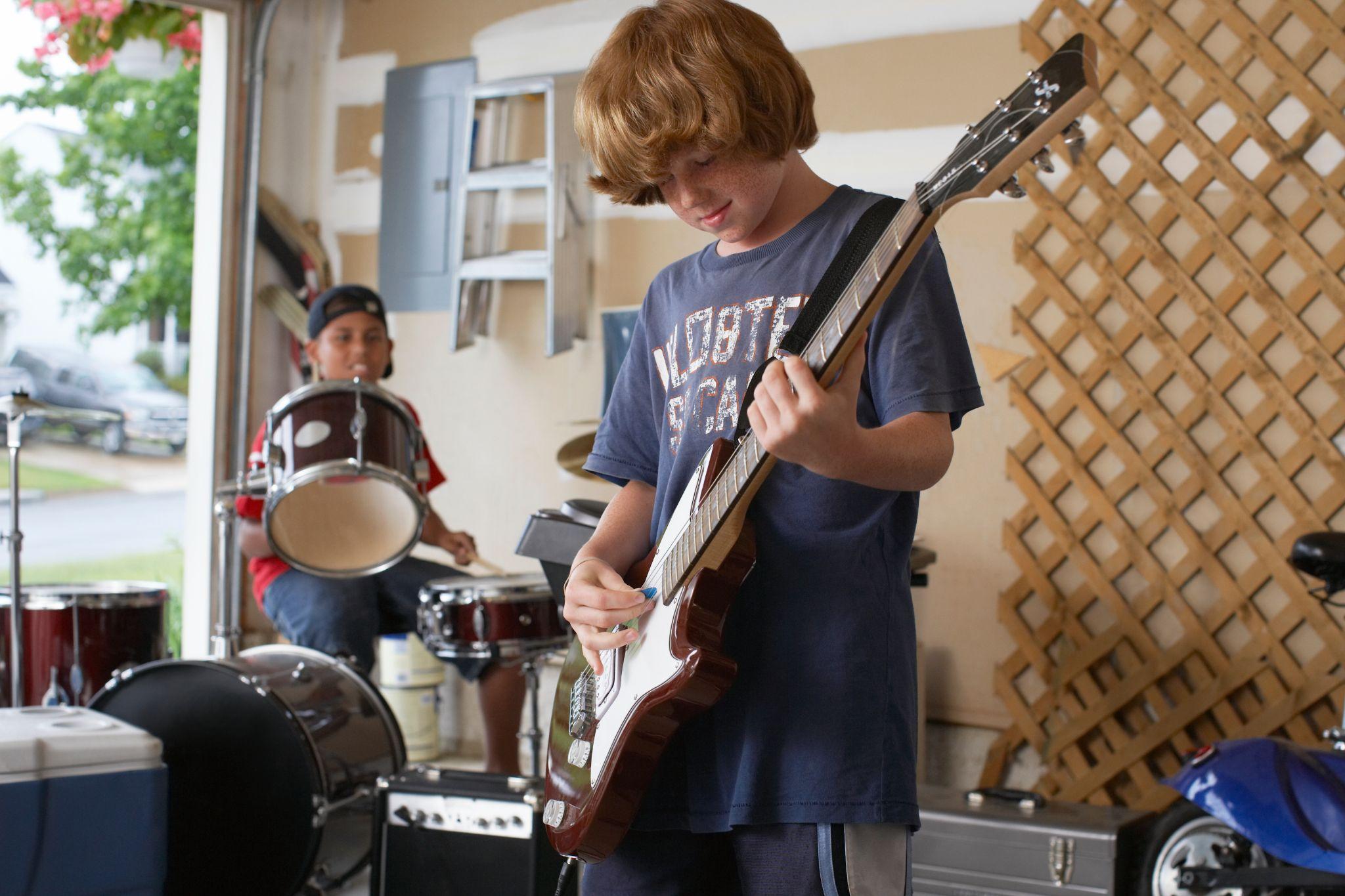 Kids playing instruments in a garage