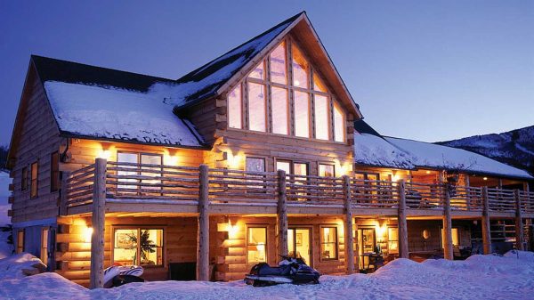 eLoghomes Silver Springs model with glowing exterior lights at dusk.