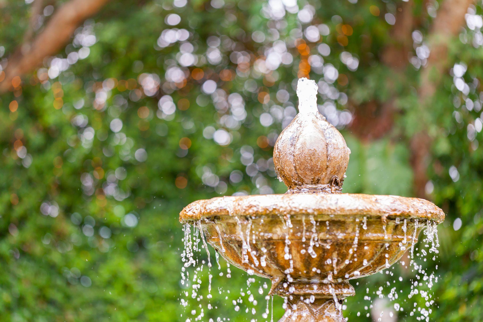 Fountain water feature in log home landscape
